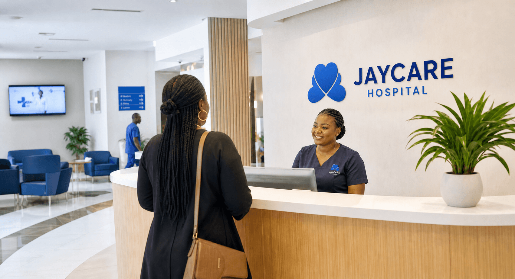 A Jaycare receptionist welcoming a visitor at the hospital reception desk